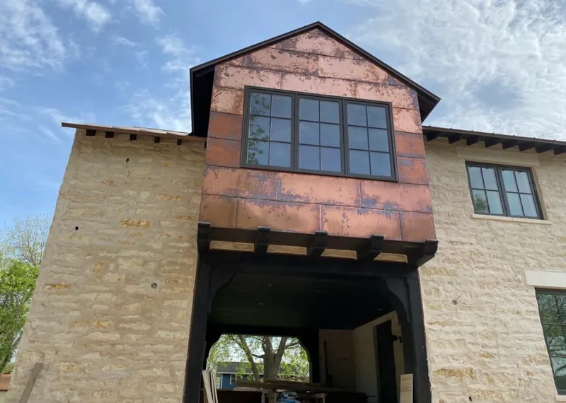 Copper metal panel facade on a stone building for Skylight Installation in Roseville