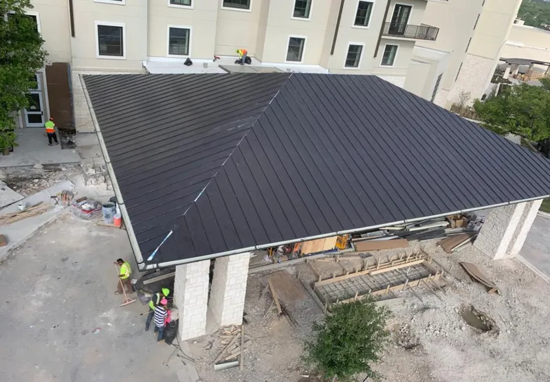 Metal roofing installation team working on a commercial building in Roseville